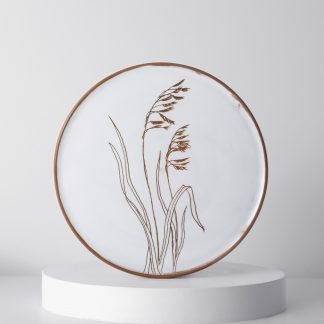 A Wildflower plate showing handcarved botanics on a handthrown plate, by Gallery Nordeinde